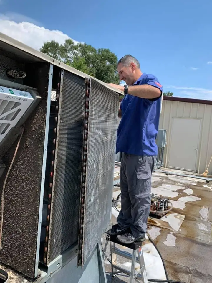 A Greater Air & Heating technician servicing a rooftop unit